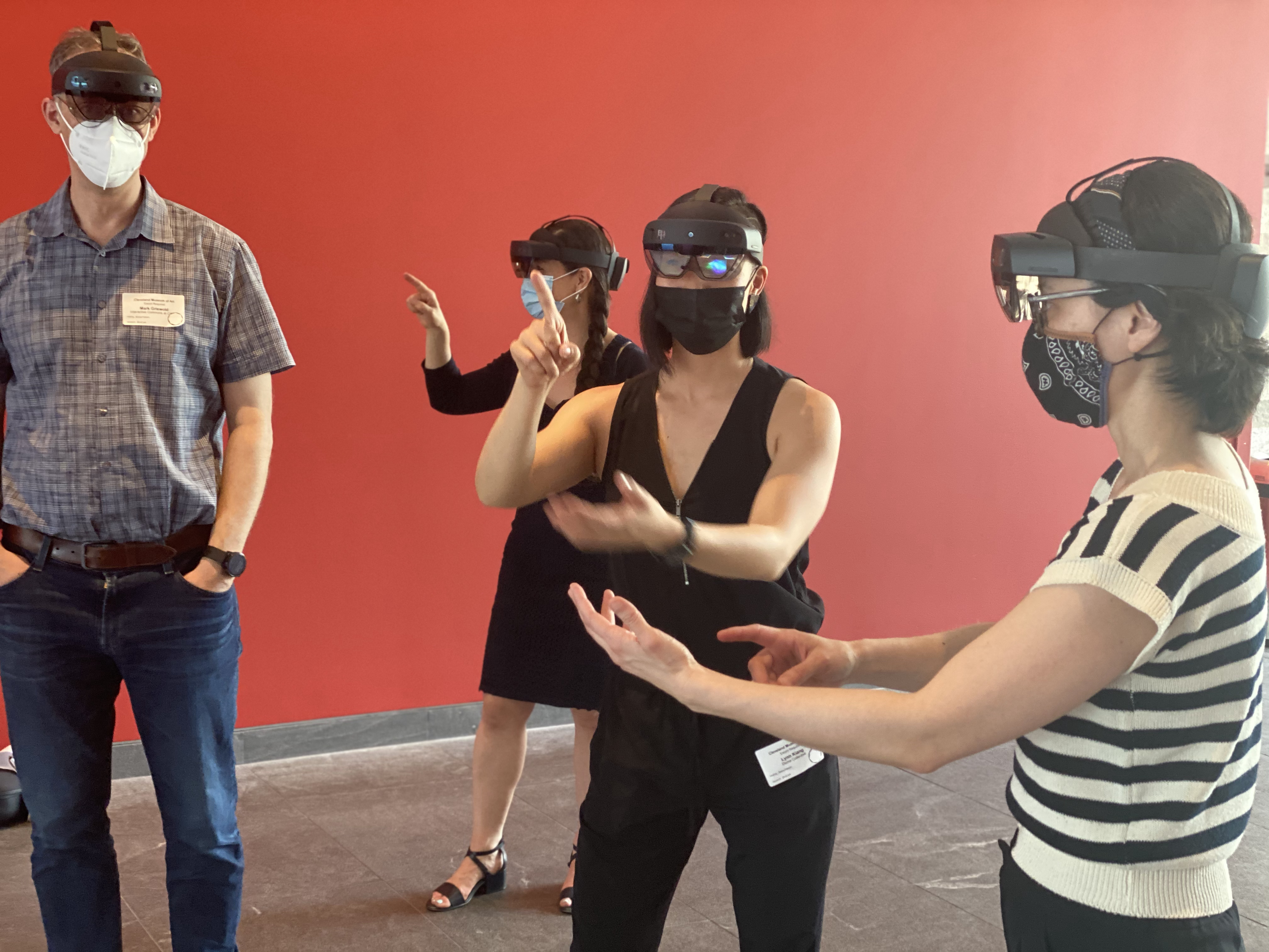 people in AR headsets interacting with an unseen landscape
