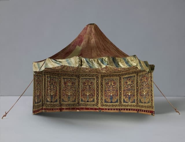 Exterior view of a round tent with a sagging, muted red, peaked roof. The front flap of the tent is rolled up to reveal the interior with seven rectangles filled with predominantly muted red, blue, green, and yellow colors and framing elaborate stylized vases from which sprout flowers. Intricate floral and vine motifs extend across the walls and onto the ceiling.