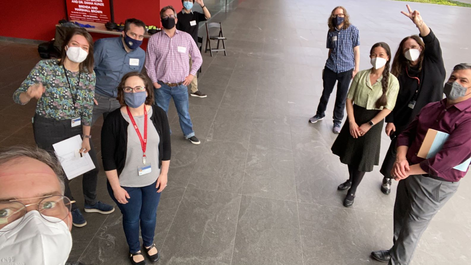 a group of people wearing masks standing together